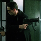 Neo opens fire in two directions in The Matrix's iconic lobby shoot-out scene.